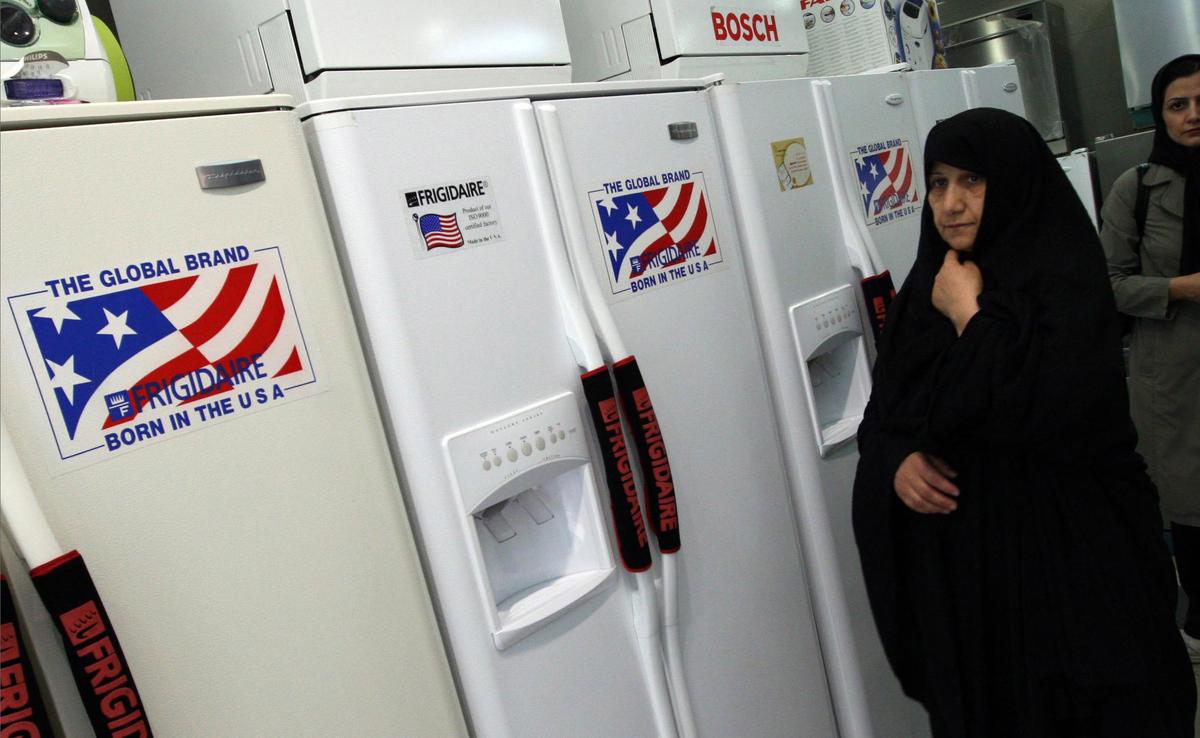 An Iranian shopper examines what appear to be American-brand refrigerators at a store in Tehran, Iran, recently. (Associated Press / The Spokesman-Review)