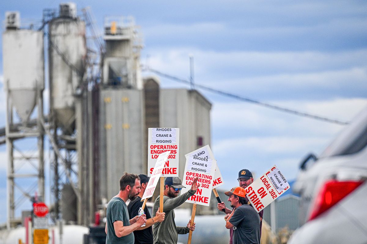 Picketers march in front of Central Pre-Mix in Spokane Valley on Friday, August 15, 2025. The labor strike has indefinitely halted three construction projects in Eastern Washington, including the North Spokane Corridor.  (Kathy Plonka/The Spokesman-Revie)
