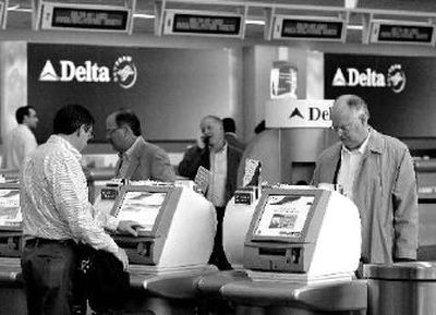 
Delta passengers take advantage of self-service check-in terminals at Logan Airport in Boston last month. The airline ranked near the bottom in a survey of customer satisfaction. 
 (Associated Press / The Spokesman-Review)