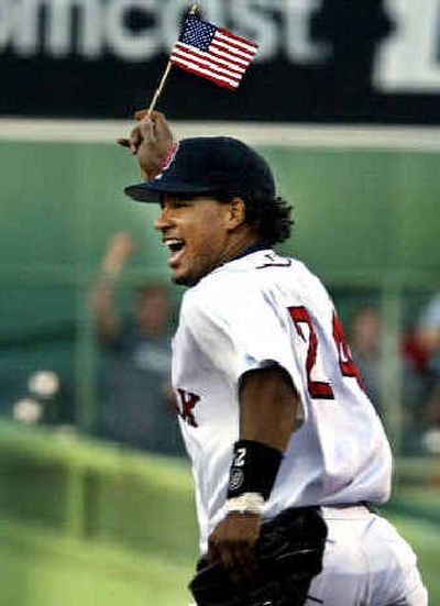 
Boston Red Sox left fielder and new American citizen Manny Ramirez waves a flag as he takes the field at Fenway Park.Boston Red Sox left fielder and new American citizen Manny Ramirez waves a flag as he takes the field at Fenway Park.
 (Associated PressAssociated Press / The Spokesman-Review)