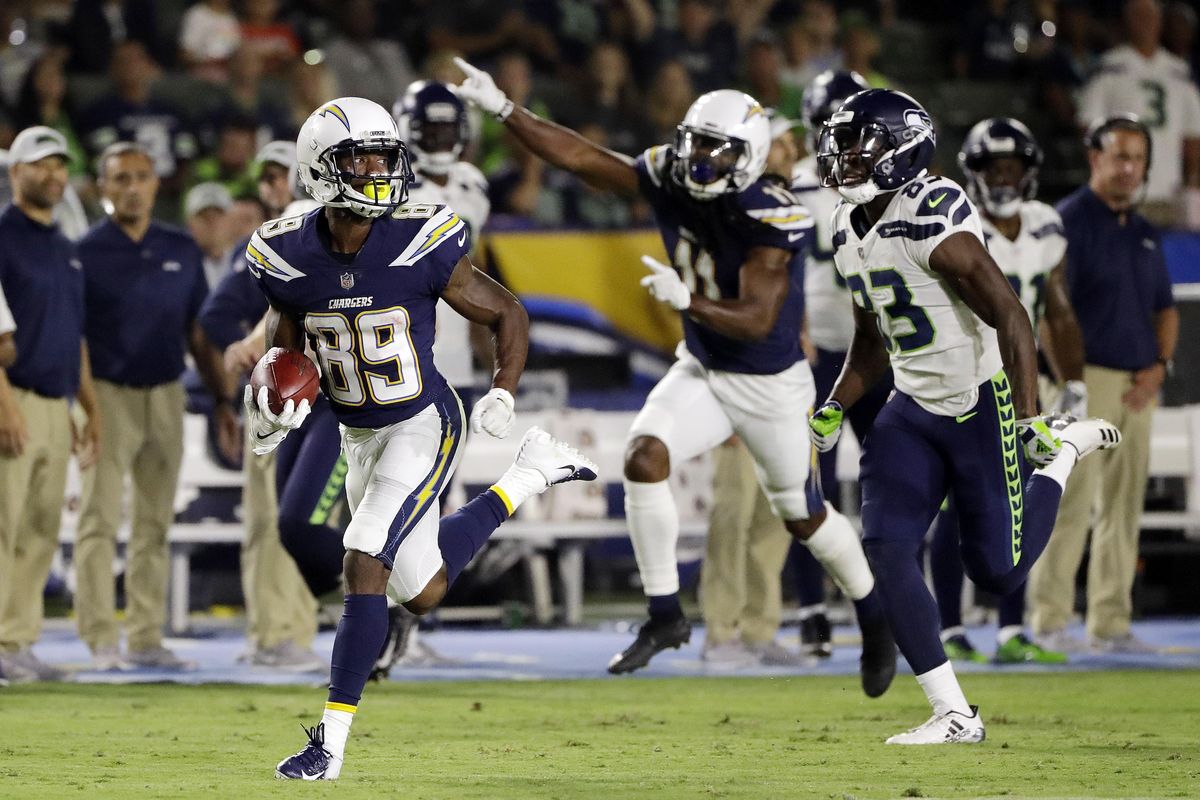 Los Angeles Chargers’ J.J. Jones  returns a punt for a touchdown past Seattle Seahawks’ Neiko Thorpe, right, during the first half Saturday  in Carson, Calif. (Gregory Bull / AP)