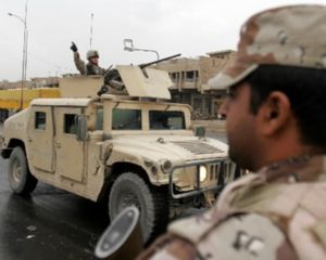 A US soldier gestures from a humvee as he patrols a street, in Baghdad, on Oct. 29, 2005. (AP File Photo/Mohammed Uraibi)