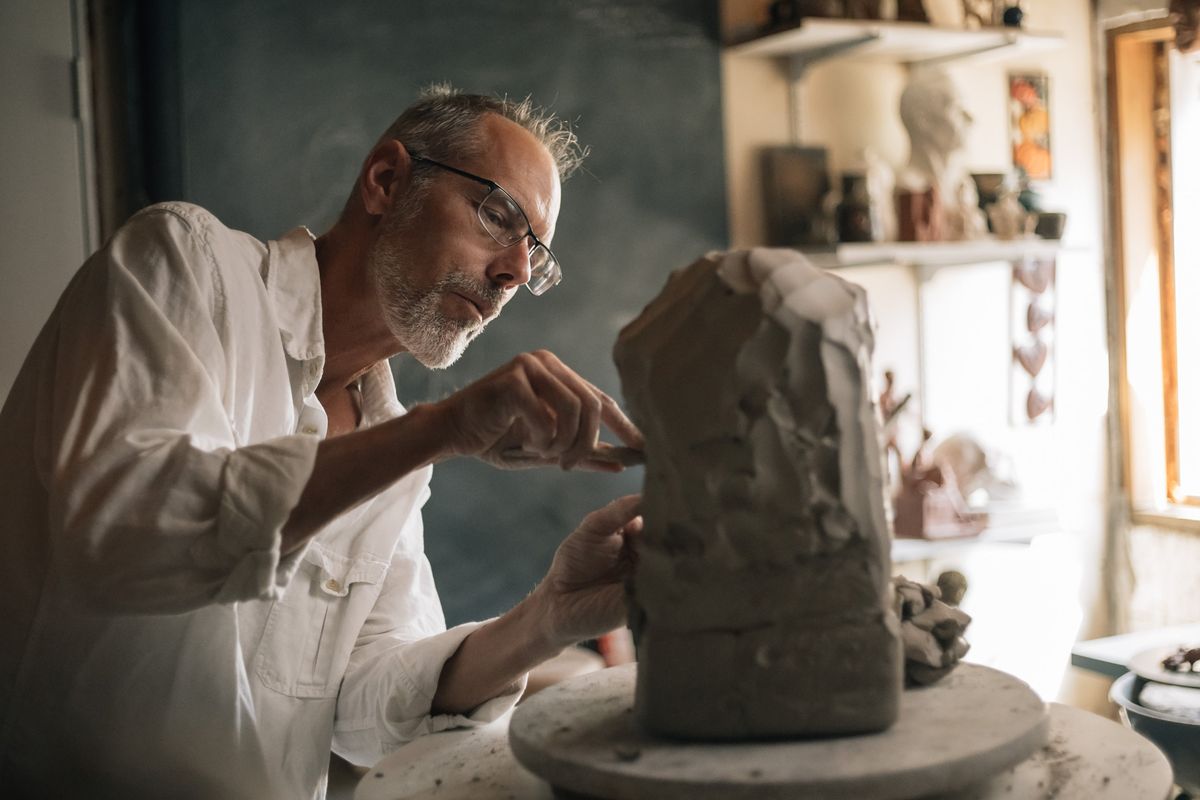 Gerry Kulzer, an art teacher and sculptor, practices with clay ahead of the Minnesota State Fair, where he’ll be the new resident butter sculptor, in his studio in Litchfield, Minn., Aug. 14, 2022. Kulzer is ready to capture the likenesses of the dairy princesses, if only he can sculpt their tresses in time.  (Nate Ryan/The New York Times)