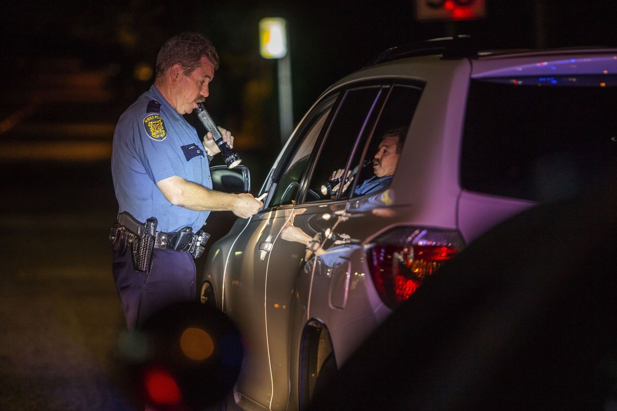Seattle police Officer Mike Lewis, who is part of a group of more than 200 law-enforcement personnel around the state who have been specially trained to spot and evaluate motorists impaired by drugs and alcohol, makes a routine traffic stop earlier this month.