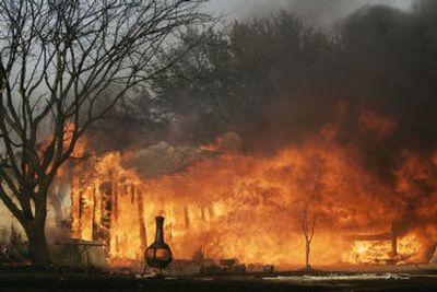 
Grass fires driven by gusty wind damaged several homes in Oklahoma and north Texas on Tuesday, including this mobile home in South Arlington, Texas. 
 (Associated Press / The Spokesman-Review)