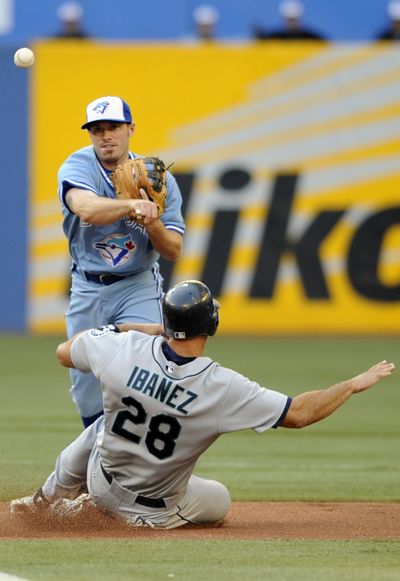 Seattle’s Raul Ibanez is out at second base as Joe Inglett turns the double play.  (Associated Press / The Spokesman-Review)