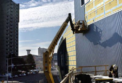 
Workers apply metal siding to the outside of the new Spokane Convention Center Monday afternoon.
 (Holly Pickett photos/ / The Spokesman-Review)