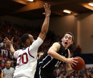Gonzaga forward Kyle Wiltjer, right, looks to shoot the ball over Saint Mary’s forward Desmond Simmons during first-half action. (Associated Press)