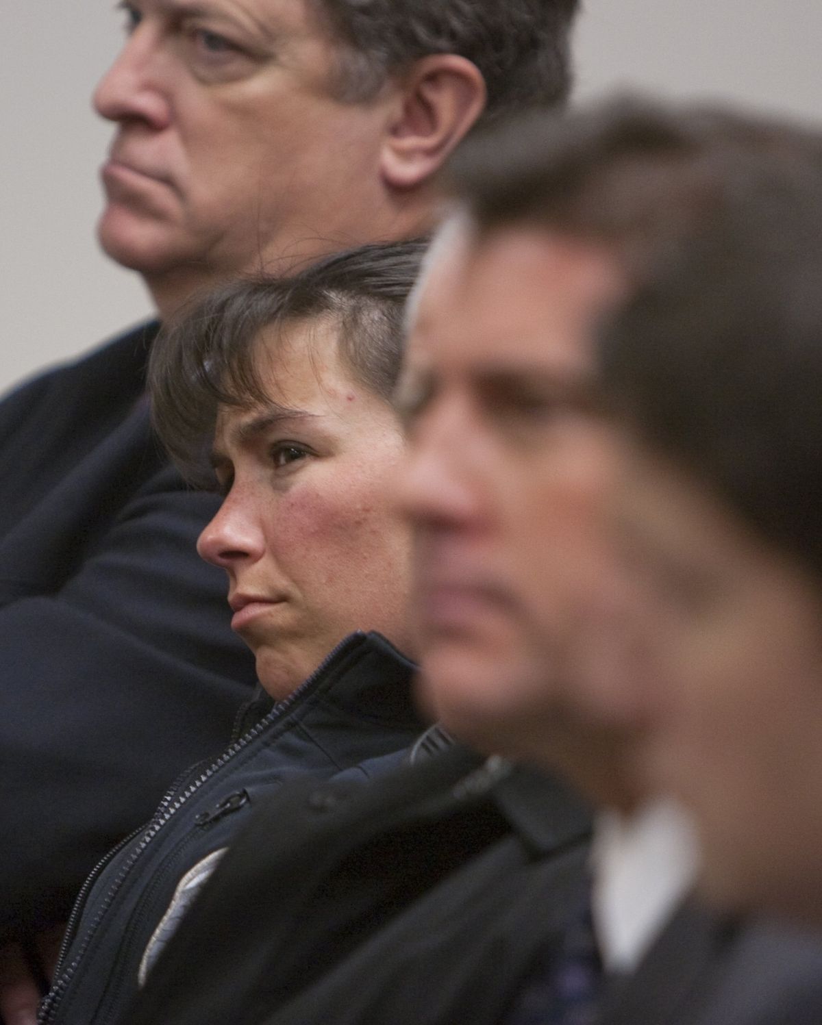 Seattle police Officer Britt Sweeney looks on during jury selection  Monday. Sweeney was injured and her partner, Seattle Officer Timothy Brenton, was killed in a shooting on Oct. 31.