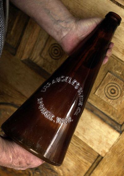 
Mary Ann Ebeltoft holds a wine bottle she found under her grandmother's porch 50 years ago. The wine bottle says Los Angles Wine Co., Spokane Washington. 
 (Jed Conklin / The Spokesman-Review)