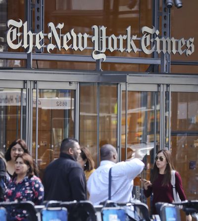 In this Tuesday, May 2, 2017, photo, people walk by the New York Times headquarters in New York. On Wednesday, May 31, 2017, the New York Times announced it is ditching its public editor position that was started in 2003 after the Jayson Blair plagiarism scandal to improve its credibility with readers. (Bebeto Matthews / Associated Press)