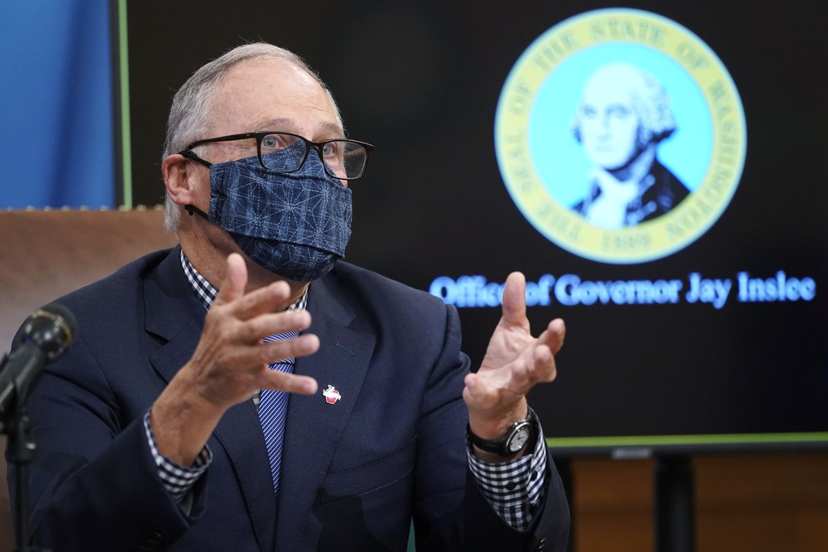 Washington Gov. Jay Inslee talks to reporters about COVID-19 restrictions at the Capitol in Olympia.  (Ted S. Warren)