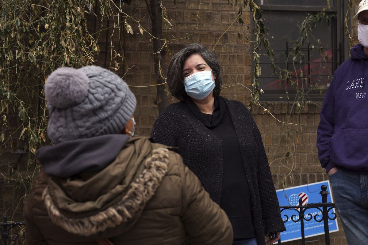 Sofia Moncayo, who leads a food distribution program through Mosaic West Queens Church in the Sunnyside neighborhood of the Queens borough of New York, speaks Monday with a donation recipient.  (STF)