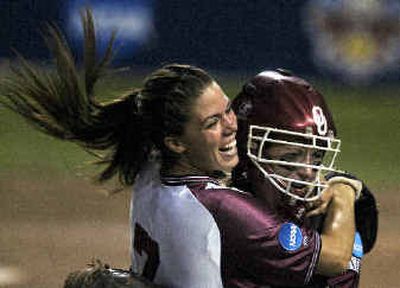 
Oklahoma pitcher Kami Keiter, left, and catcher Heather Scaglione celebrate the win over UW.Oklahoma pitcher Kami Keiter, left, and catcher Heather Scaglione celebrate the win over UW.
 (Associated PressAssociated Press / The Spokesman-Review)
