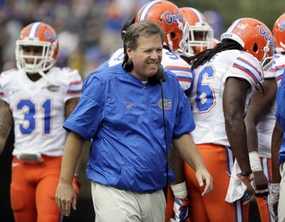 FILE - In this Oct. 1, 2016, file photo, Florida head coach Jim McElwain walks the field during a timeout in the second half of an NCAA college football game against Vanderbilt, in Nashville, Tenn. McElwain has a defensive makeover on his hands. The 20th-ranked Gators (8-4) lost defensive coordinator Geoff Collins, who was hired as Temples head coach Tuesday, and could lose as many as eight defensive starters to the NFL. (Mark Humphrey / Associated Press)