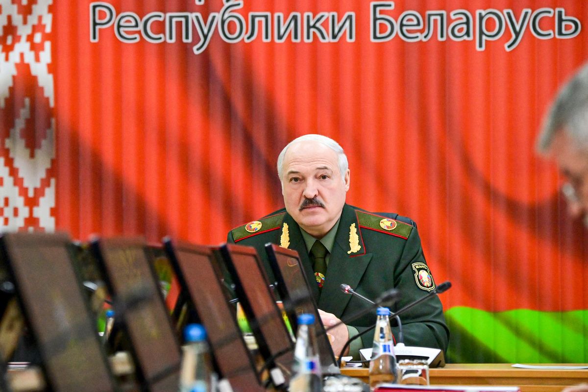FILE - Belarusian President Alexander Lukashenko attends a meeting with top level military officials in Minsk, Belarus, on Nov. 22, 2021. A human rights group in Belarus says authorities have raided the homes of dozens of journalists and activists. The Viasna human rights center reported that independent journalists, human rights advocates and activists in at least nine large Belarusian cities had phones and computers seized during the searches and were interrogated.  (Andrei Stasevich)