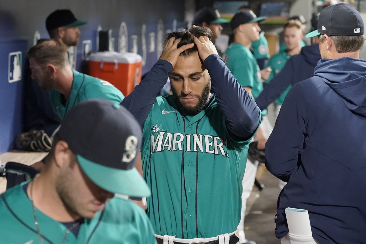 Seattle Mariners third baseman Abraham Toro, left, is late with