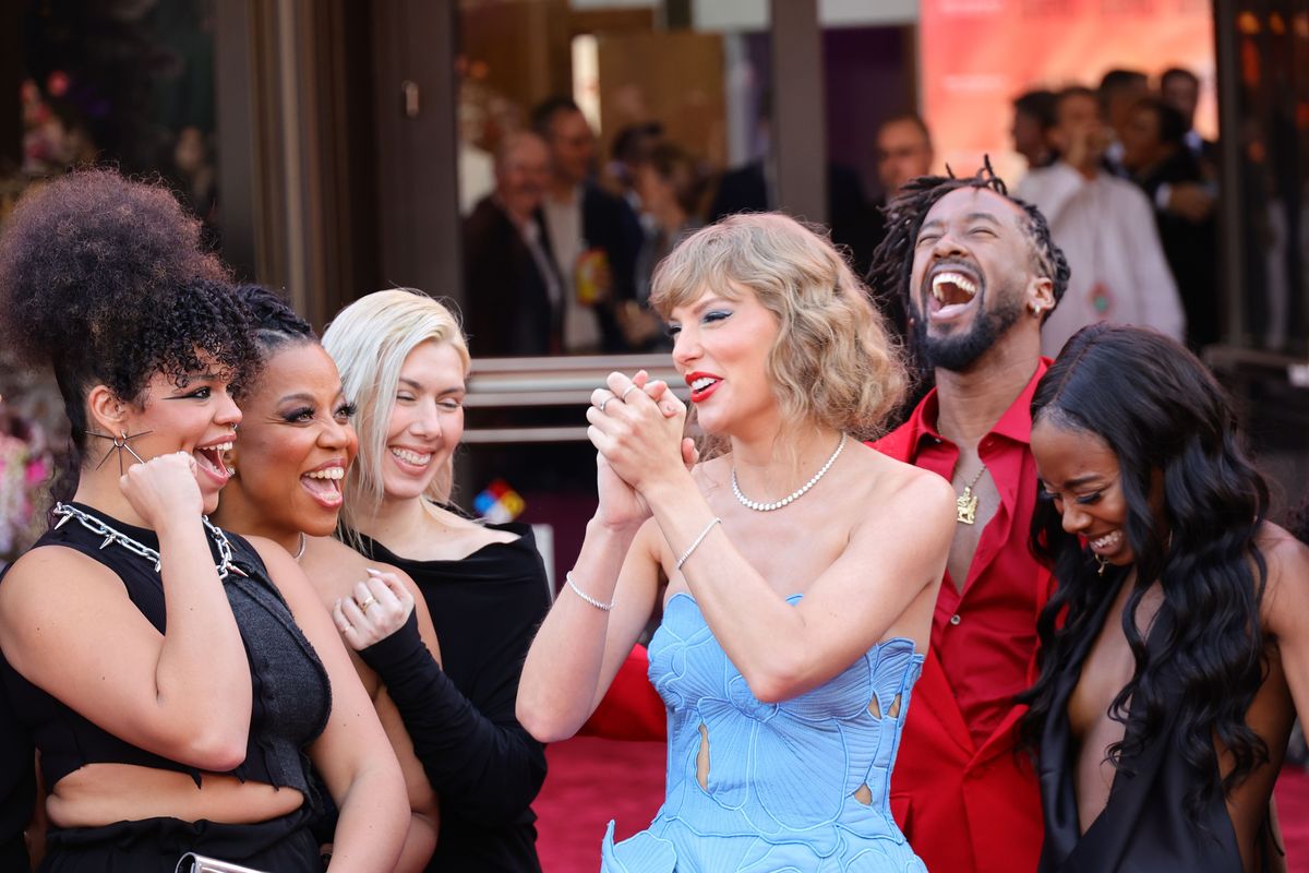 Taylor Swift, surrounded by dancers and tour crew, attends “Taylor Swift: The Eras Tour” Concert Movie World Premiere at AMC The Grove 14 on Oct. 11 in Los Angeles.  (Getty Images)