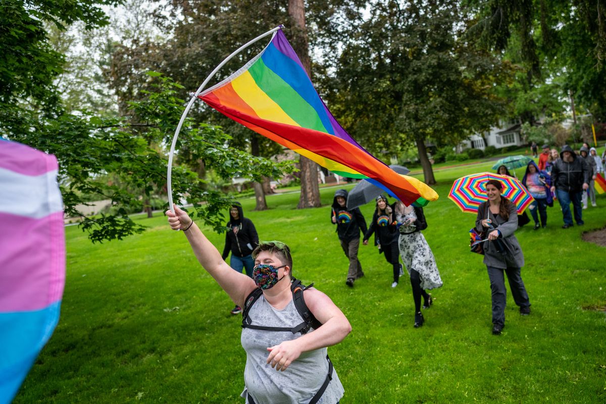 As part of the Pride in the Park event, April Hoy waves a rainbow flag during a “Pride Stride” march in Coeur d’Alene City Park in June 2022.  (COLIN MULVANY/THE SPOKESMAN-REVIEW)