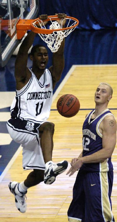 
Connecticut's Hilton Armstrong dunks over Washington's Mike Jensen. 
 (Associated Press / The Spokesman-Review)