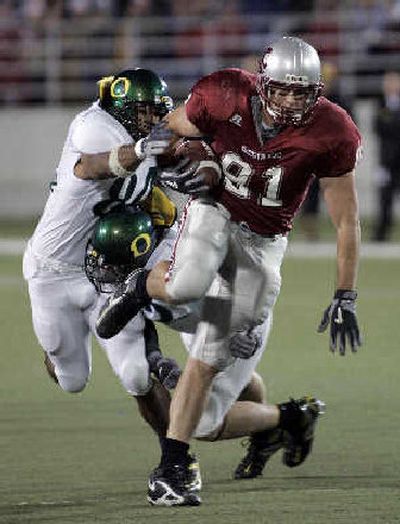 
WSU's Troy Bienemann breaks a tackle before fumbling the ball, which was recovered by WSU. 
 (Christopher Onstott/ / The Spokesman-Review)