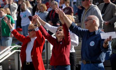 
Supporters of Initiated Measure 6 raise their hands at Mount Rushmore National Memorial on Saturday. The proposed law would ban nearly all abortions in the state. 
 (Associated Press / The Spokesman-Review)