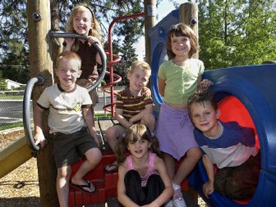 
The Cromwell triplets, Matthew (left front), Katie (left rear) and Alex (center with striped shirt) and the Suton triplets, Ali (center front), Tessa (right standing) and Hunter (right) will be in kindergarten at Hamblen Elementary this fall. 
 (Dan Pelle / The Spokesman-Review)