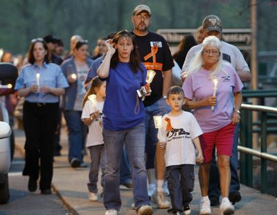 People walk through town during a candlelight vigil Wednesday in Whitesville, W. Va., for miners involved in an explosion at Massey Energy Co.’s Upper Big Branch mine.  (Associated Press)