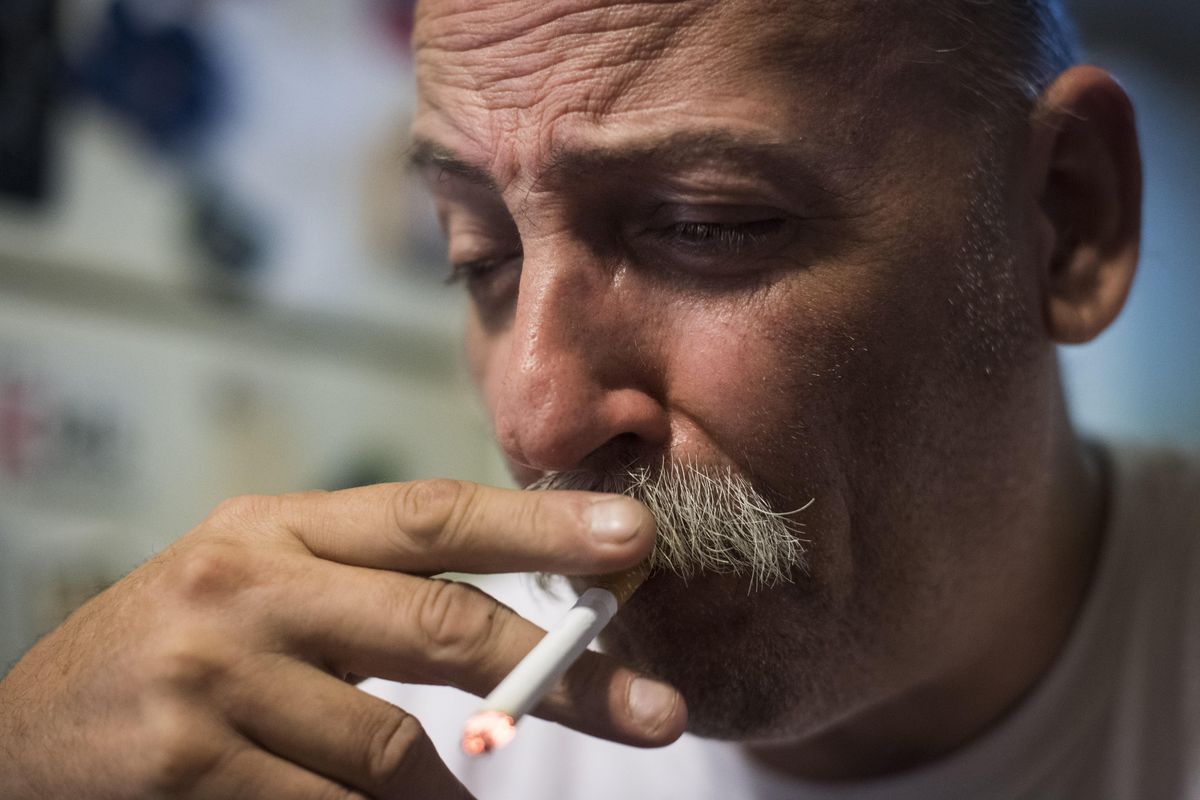 Jim Cooley smokes a cigarette as he rests after doing errands at his home in Winder, Ga. MUST CREDIT: Washington Post photo by Jabin Botsford. (Jabin Botsford / Washington Post)