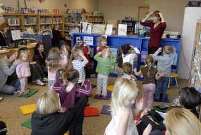 
Children's library associate Amy Dickeson leads a group of toddlers, preschoolers and moms during storytime at the Liberty Lake Children's Library Tuesday. Liberty Lake residents will vote on a $9.8 million  bond in April that would  expand the library facility from 3,200 square feet and create a dual purpose 10,700 square foot library and community center.
 (Photos by J. BART RAYNIAK / The Spokesman-Review)