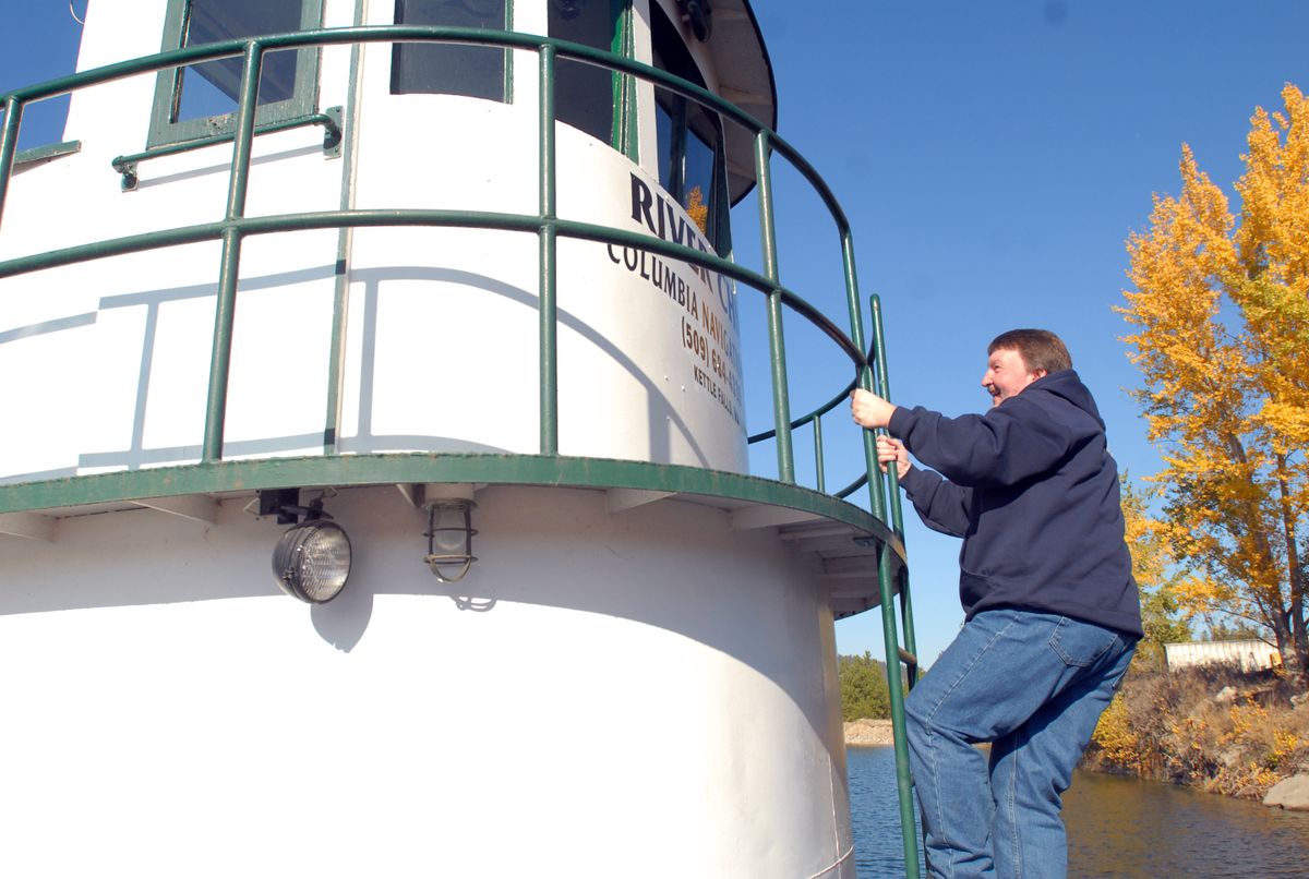 Eric Weatherman, of Kettle Falls, Wash., climbs onto his tugboat on Lake Roosevelt on Thursday.  Weatherman weighs 300 lbs., down  from  430 lbs. thanks to duodenal switch bariatric surgery. He says he can now climb ladders without running out of breath.  (Jesse Tinsley / The Spokesman-Review)