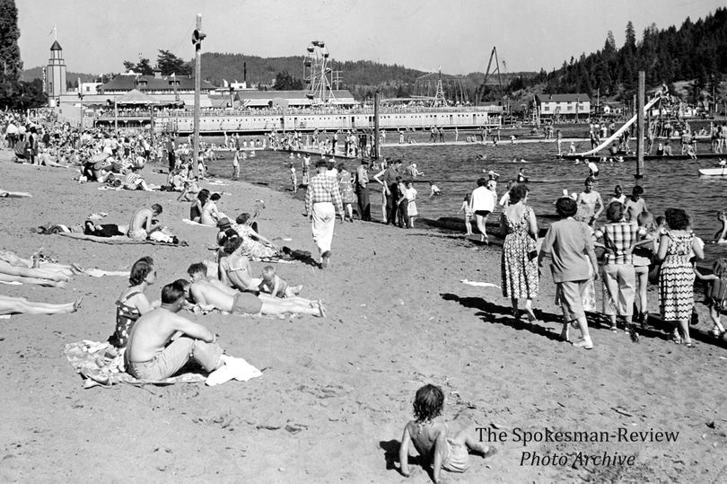 Bathers throng to the beach in Coeur d'Alene in 1949 with Playland in the background. Spokesman-Review photo archive.