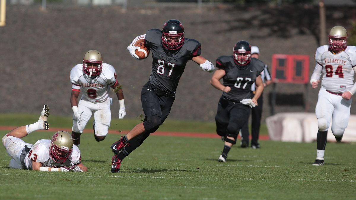 Whitworth receiver Connor Williams runs with the ball against Willamette during the Pirates’ 61-45 shootout win over the Bearcats. (TYLER TJOMSLAND PHOTOS)