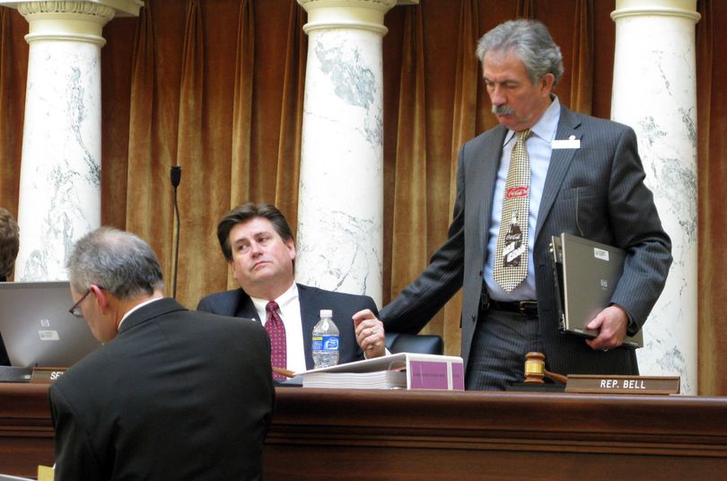 Idaho Sen. Jim Hammond, R-Post Falls, right, reassures Senate Finance Chairman Dean Cameron, center, after a somber and contentious budget-setting session for public schools on Wednesday. At left is Paul Headlee, legislative budget analyst for public schools.  BETSY RUSSELL (Betsy Russell / The Spokesman-Review)