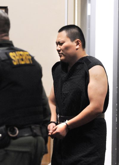 John Lee is escorted Monday into Superior Court in Colfax for his first appearance on a felony eluding charge. Lee is suspected of fatally shooting three people – including his mother – before leading authorities on a high-speed chase. He is fighting extradition to Idaho. (Associated Press)