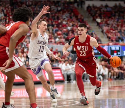 Washington State forward Andrej Jakimovski, right, drives past Washington forward Moses Wood in the first half on Thursday, March 7, 2024, at Beasley Coliseum in Pullman.  (Geoff Crimmins/For The Spokesman-Review)
