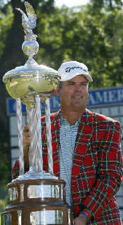 
Kenny Perry poses with the Leonard Trophy after winning the Colonial. 
 (Associated Press / The Spokesman-Review)