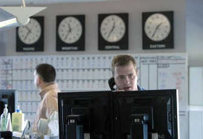 
Brandon Taylor, a real-time trader for Shell Energy in Spokane, talks with electric customers in California on Friday. 
 (Dan Pelle / The Spokesman-Review)