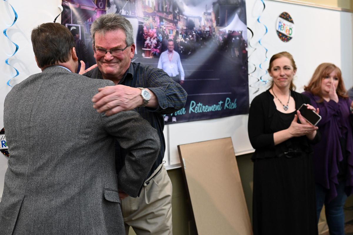 At a retirement party for Rich Hartzell, the director of the Spokane County Fair and Expo Gerry Gemmill, CEO of Spokane County, left, gives Hartzell a goodbye hug, Thurs., Feb 21, 2019, at the Spokane County Fair and Expo. (Colin Mulvany / The Spokesman-Review)