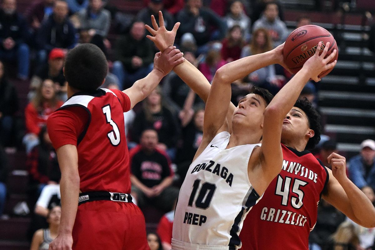Gonzaga Prep’s Jacob Parola  heads to the basket for a layup as Sunnyside’s Art Palacios, left, and Ismael Zavala defend during the first half Friday of a  4A regional  at University High School. G-Prep won 80-44 (Colin Mulvany / The Spokesman-Review)