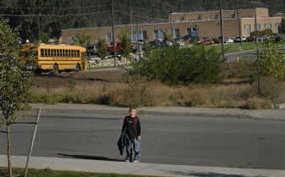 
Trent Elementary  fourth-grader Michael Braucht looks back at his mother after just missing his bus Wednesday, the first day of school. Children from the Parkside apartments have no safe crossing over Pines Road and have to  be bused the two-tenths of a mile. 
 (Brian Plonka / The Spokesman-Review)