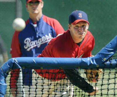 
Spokane Indians pitching coach Mike Anderson, background, observes  Neil Ramirez during Saturday's practice at Avista Stadium. 
 (Dan Pelle / The Spokesman-Review)