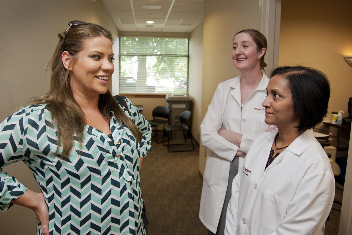 From left, Rockwood Breast Clinic patient Katherine Gawenit visits with Drs. Moira O’Riordan and Renu Sinha. (Dan Pelle)