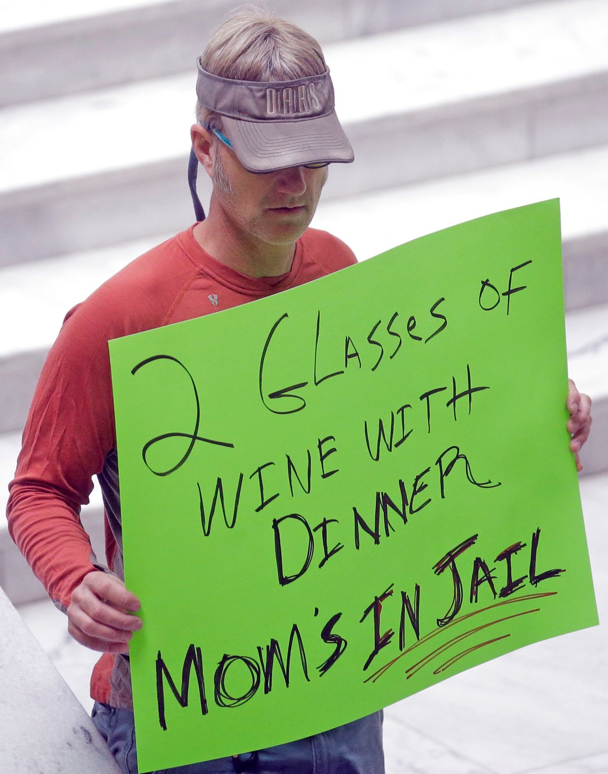 FILE—In this March 17, 2017, file photo, a protester holds a sign during a rally concerning the DUI threshold at the Utah State Capitol in Salt Lake City. Car crashes and traffic deaths decreased in Utah the after state enacted the strictest drunken driving laws in the nation. A study published, Friday, Feb. 11, 2022, by the National Highway Traffic Safety Administration suggests Utah's roads became safer after the state lower the drunken driving threshold to .05% blood-alcohol content.  (Rick Bowmer)