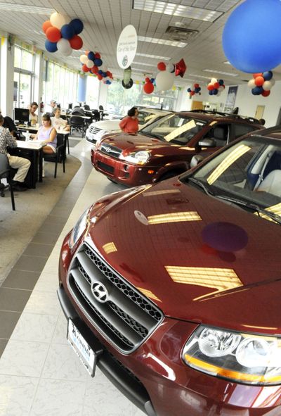 People shop for cars at Hyundai Village in Danvers, Mass. Korean automaker Hyundai and its affiliate Kia bested Chrysler in the U.S. market in August, selling 100,665 vehicles.  (File Associated Press / The Spokesman-Review)