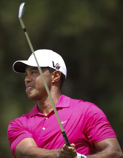 Tiger Woods of the United States watches his shot on the eighth hole during the third round of CIMB Classic. He shot 2-under 69. (Associated Press)