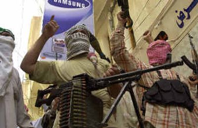 
Shiite militiamen take up a position in the center of Karbala on Sunday.Shiite militiamen take up a position in the center of Karbala on Sunday.
 (Associated PressAssociated Press / The Spokesman-Review)