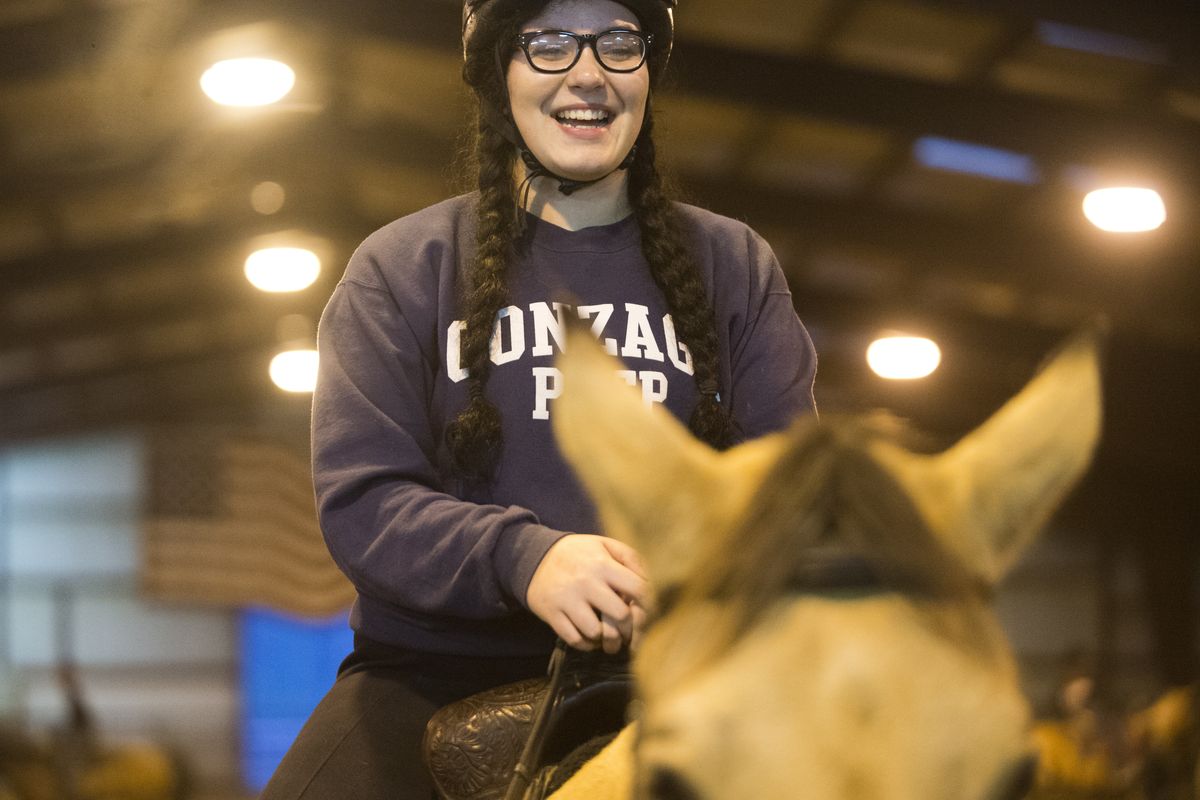 Elizabeth Crandall, 14, talks about the fun she and other members of the Mt. Spokane Equestrian Team were having Oct. 29 at FAB Quarterhorses while practicing drill routines for next spring’s Washington High School Equestrian Team events. (Jesse Tinsley)