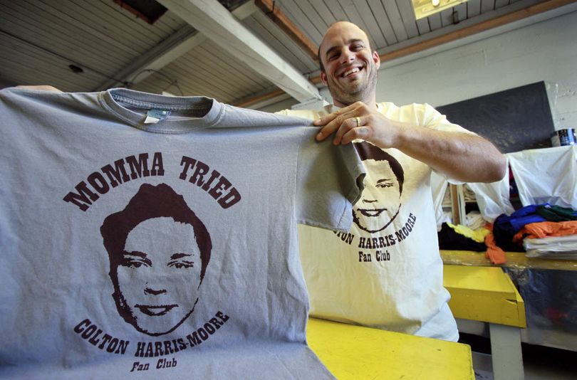 Adin Stevens displays shirts he printed on a whim weeks ago celebrating teenage fugitive  Colton  Harris- Moore Tuesday, Oct. 6, 2009, in his printing shop in Seattle. Whenever police get near  Harris- Moore, the teen seems to disappear and the crime spree is beginning to feel like something out of the movie 