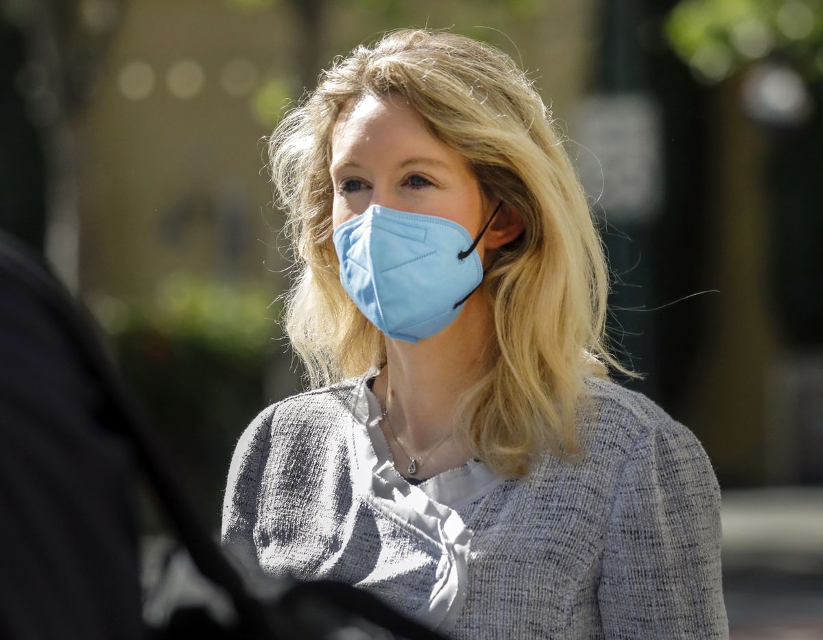 FILE - Elizabeth Holmes, founder and CEO of Theranos, left, leaves the Robert F. Peckham Federal Building in downtown San Jose, Calif., on Tuesday, May 4, 2021. The U.S. government rested its case in the trial of fallen Silicon Valley star Elizabeth Holmes on Friday, Nov 19, after spending more than two months trying to prove she bamboozled investors, patients and business partners into believing that her startup Theranos was about to reshape health care by using just a few drops for blood for tests that usually require vials of the stuff.  (Nhat V. Meyer)